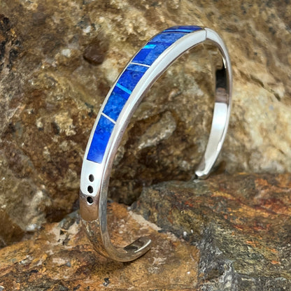 as part of the Blue Sky Collection, features Royal Lapis, Denim Lapis and Cultured Opal in a Fancy Inlaid Pattern.